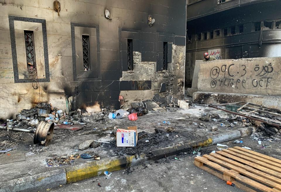 A protester checks the site of a gunmen attack in Baghdad, Iraq, Saturday, Dec. 7, 2019. Gunmen in cars opened fire Friday in Baghdad's Khilani square, killing and wounding scores of people. (AP Photo/Ali Abdul Hassan)