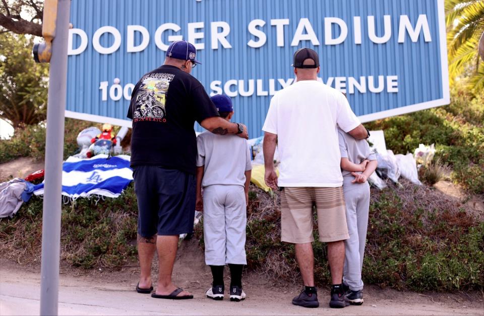 Fans pay their respects at a growing memorial outside Dodger Stadium