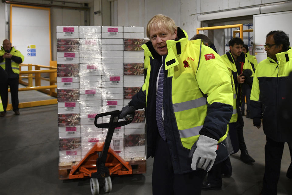 Britain's Prime Minister Boris Johnson visits the headquarters of Iceland Foods in Deeside, Wales, Friday Nov. 8, 2019. Johnson pushed hard for the early election, which is coming more than two years ahead of schedule, after Parliament thwarted his plans to have Britain leave the EU on Oct. 31. Johnson hopes to win an outright majority in Parliament so he can pass a divorce bill in time for Britain to leave by the next Brexit deadline on Jan. 31. (Daniel Leal-Olivas/Pool via AP)