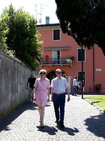 Britain's Prime Minister Theresa May walks with her husband Philip in Desenzano del Garda, by Lake Garda, northern Italy, July 25, 2017. REUTERS/Antonio Calanni/Pool