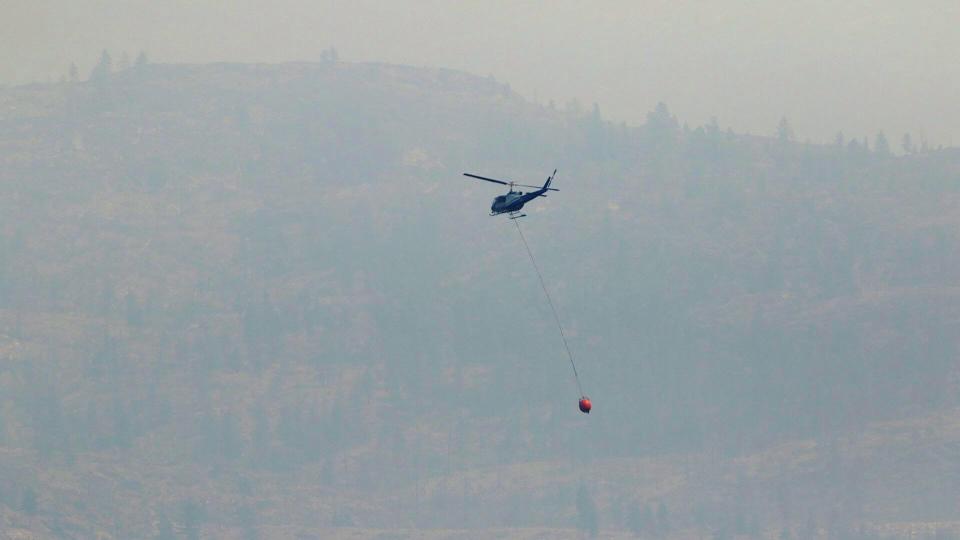 Officials in British Columbia's Okanagan region were hopeful that fire crews could aggressively tackle the flames on Saturday, as the weather forecast called for more cloud cover and less wind than in recent days.