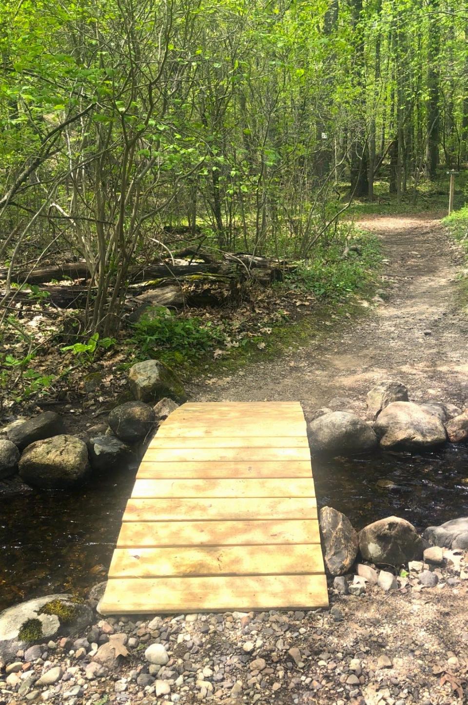 Thanks to the Trustees of Reservations for the work they do to make local walking trails safer and more inviting. This new bridge-the-gap addition at Noanet Woodlands in Dover solves a problem below the dam where high running water interrupted a red trail hiking path.