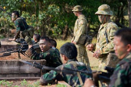 FILE PHOTO: Australian and Indonesian Army soldiers prepare for a charge on the bayonet assault course conducted by the Australian Army's Combat Training Centre in Tully, Australia, October 10, 2014. Australian Defence Force/Handout via REUTERS/File Photo