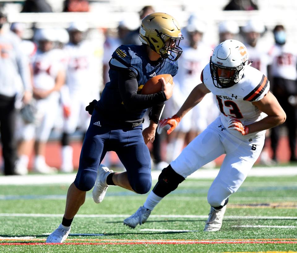 Old Tappan quarterback Charlie Amatrula, left, rushes with pressure from Somerville's Owen O'Neill (13) on Saturday, Oct. 31, 2020. Somerville defeated Old Tappan, 44-28.