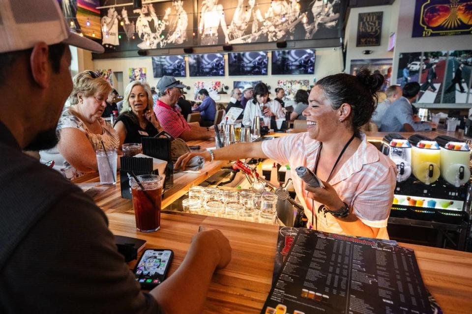 Bartender Steph Turner laughs with customers on Tuesday, July 2, 2024, at Rock & Brews in Grapevine. Turner has been a bartender for around 15 years.