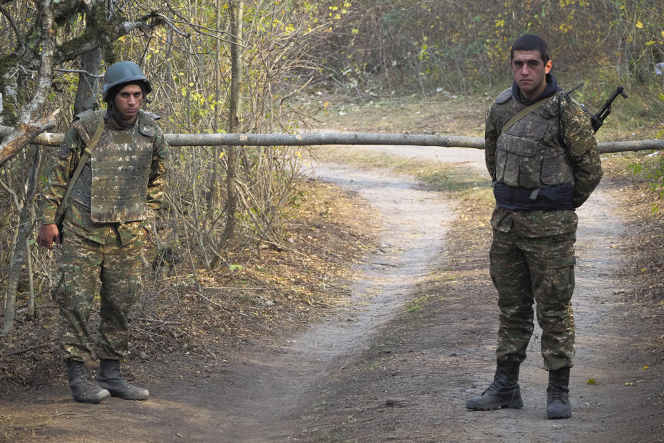 Ethnic Armenian soldiers stand at the checkpoint near the front line during a military conflict in separatist region of Nagorno-Karabakh, Monday, Nov. 2, 2020. Fighting over the separatist territory of Nagorno-Karabakh entered sixth week on Sunday, with Armenian and Azerbaijani forces blaming each other for new attacks. (AP Photo)