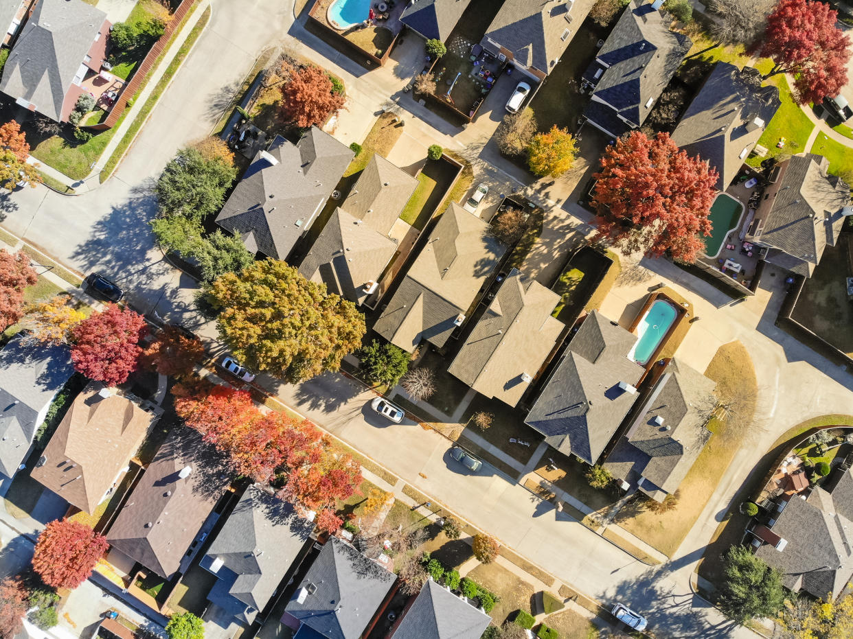 Top view residential houses with swimming pool and colorful fall foliage suburban Dallas, Texas, USA. Straight down look as satellite style.