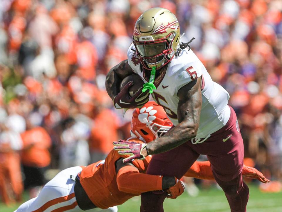 Sep 23, 2023; Clemson, South Carolina, USA; Florida State Seminoles tight end Jaheim Bell (6) runs against Clemson Tigers safety Andrew Mukuba (1) during the second quarter at Memorial Stadium. Mandatory Credit: Ken Ruinard-USA TODAY Sports Ken Ruinard/Ken Ruinard-USA TODAY Sports