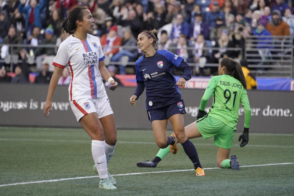 FILE - San Diego Wave forward Alex Morgan, center, reacts after she scored a goal against OL Reign goalkeeper Phallon Tullis-Joyce (91) during the first half of an NWSL soccer match Thursday, April 14, 2022, in Seattle. The San Diego Wave became the first expansion team to make the playoffs last season, paced by Alex Morgan with a league-leading 16 goals. (AP Photo/Ted S. Warren, File)