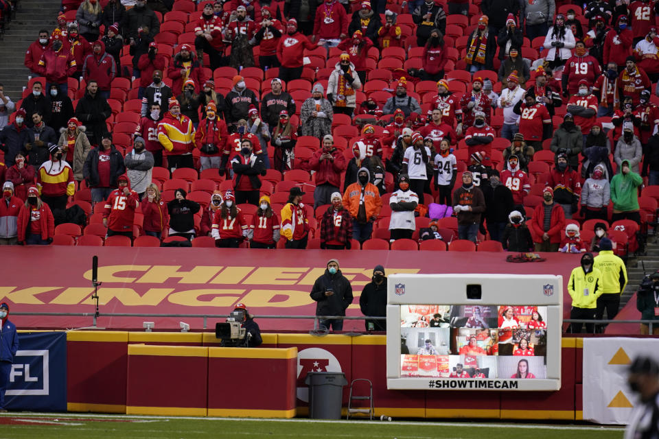 Fans watch from the stands during the second half of an NFL divisional round football game between the Kansas City Chiefs and the Cleveland Browns, Sunday, Jan. 17, 2021, in Kansas City. (AP Photo/Jeff Roberson)