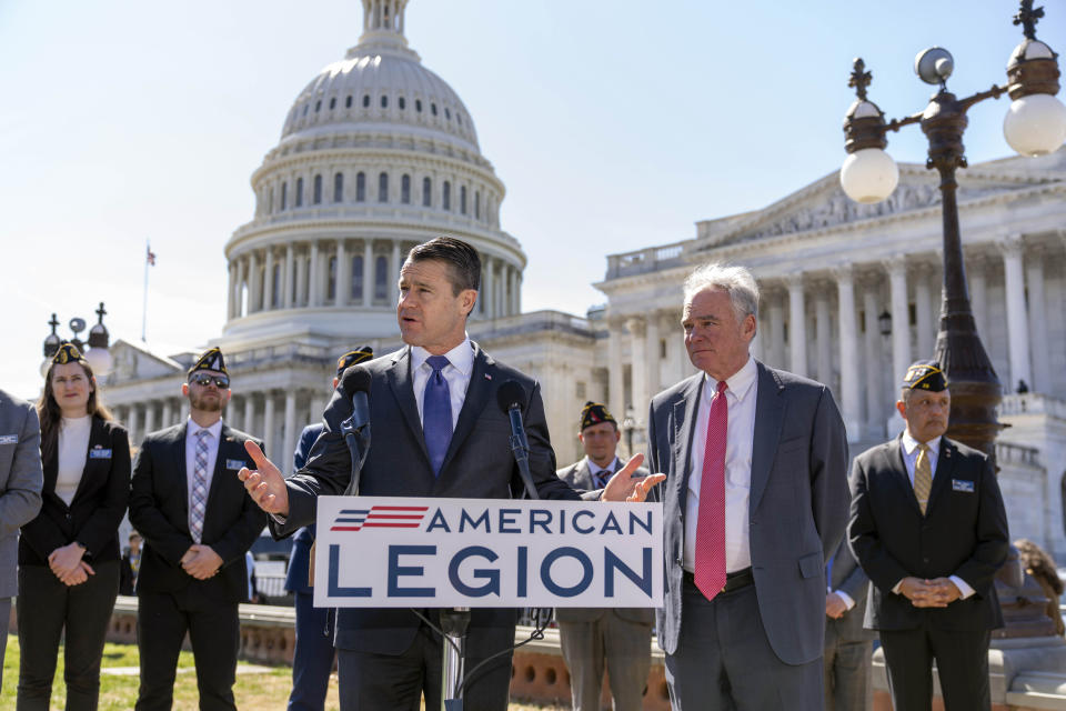 Sen. Todd Young, R-Ind., center, and Sen. Tim Kaine, D-Va., right, are joined by representatives of the American Legion as they speak to reporters about ending the authorization for use of military force enacted after the Sept. 11, 2001 terrorist attacks, at the Capitol in Washington, Thursday, March 16, 2023. Senators voted 68-27 Thursday to move forward with a bill to repeal the 2002 measure that authorized the March 2003 invasion of Iraq and a 1991 measure that sanctioned the U.S.-led Gulf War to expel Iraqi leader Saddam Hussein's forces from Kuwait. (AP Photo/J. Scott Applewhite)