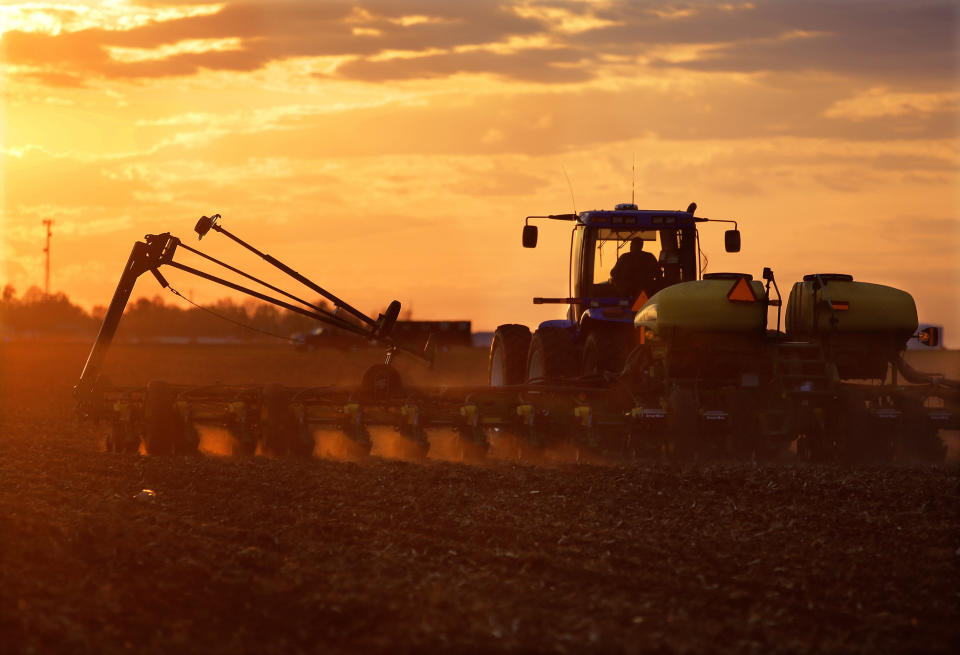 In this Saturday, May 3, 2014 photo, central Illinois corn and soybean farmer Michael Mahoney races against a setting sun to plant seed corn in Ashland, Ill. A U.S. government report says the nation's corn growers should have banner production this year despite lesser acreage devoted to the grain. But corn prices later in the year may suffer a bit. (AP Photo/Seth Perlman)
