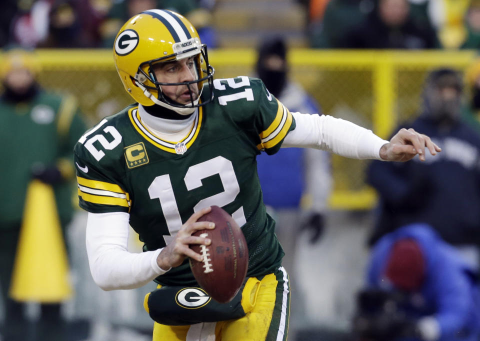 Green Bay Packers quarterback Aaron Rodgers (12) scrambles during the first half of an NFL wild-card playoff football game against the San Francisco 49ers, Sunday, Jan. 5, 2014, in Green Bay, Wis. (AP Photo/Mike Roemer)