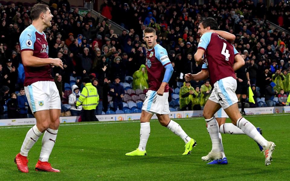 James Tarkowski (left) was given Burnley's first goal after Jack Cork's (No 4) shot deflected off his team-mate and into the Brighton & Hove Albion goal at Turf Moor on Saturday afternoon - PA