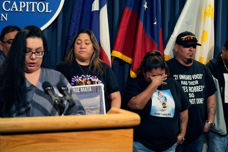 Felicia Martinez, mother of Xavier Lopez, who was killed by a gunman at Robb Elementary School in Uvalde, center, tries to hold back tears as she and other family members attend a news conference at the Texas Capitol with Texas state Sen. Roland Gutierrez in Austin on Jan. 24. For the first time since the Uvalde school massacre, Texas Republican lawmakers on Tuesday allowed proposals for stricter gun laws to get a hearing in the state Capitol ‒ even though new restrictions have almost no chance of passing.