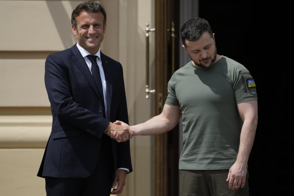 French President Emmanuel Macron, left, shakes hands with Ukrainian President Volodymyr Zelenskyy at the Mariyinsky Palace in Kyiv, Ukraine, Thursday, June 16, 2022. Four European leaders, of France, Italy, Germany and Romania, made a high-profile visit to Ukraine, where they were saw the ruins of a Kyiv suburb on Thursday and denounced the brutality of a Russian invasion that has killed many civilians. (AP Photo/Natacha Pisarenko)