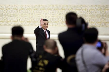 China's Premier Li Keqiang waves as he arrives at a news conference following the closing ceremony of China's National People's Congress (NPC) at the Great Hall of the People in Beijing, China, March 16, 2016. REUTERS/Jason Lee