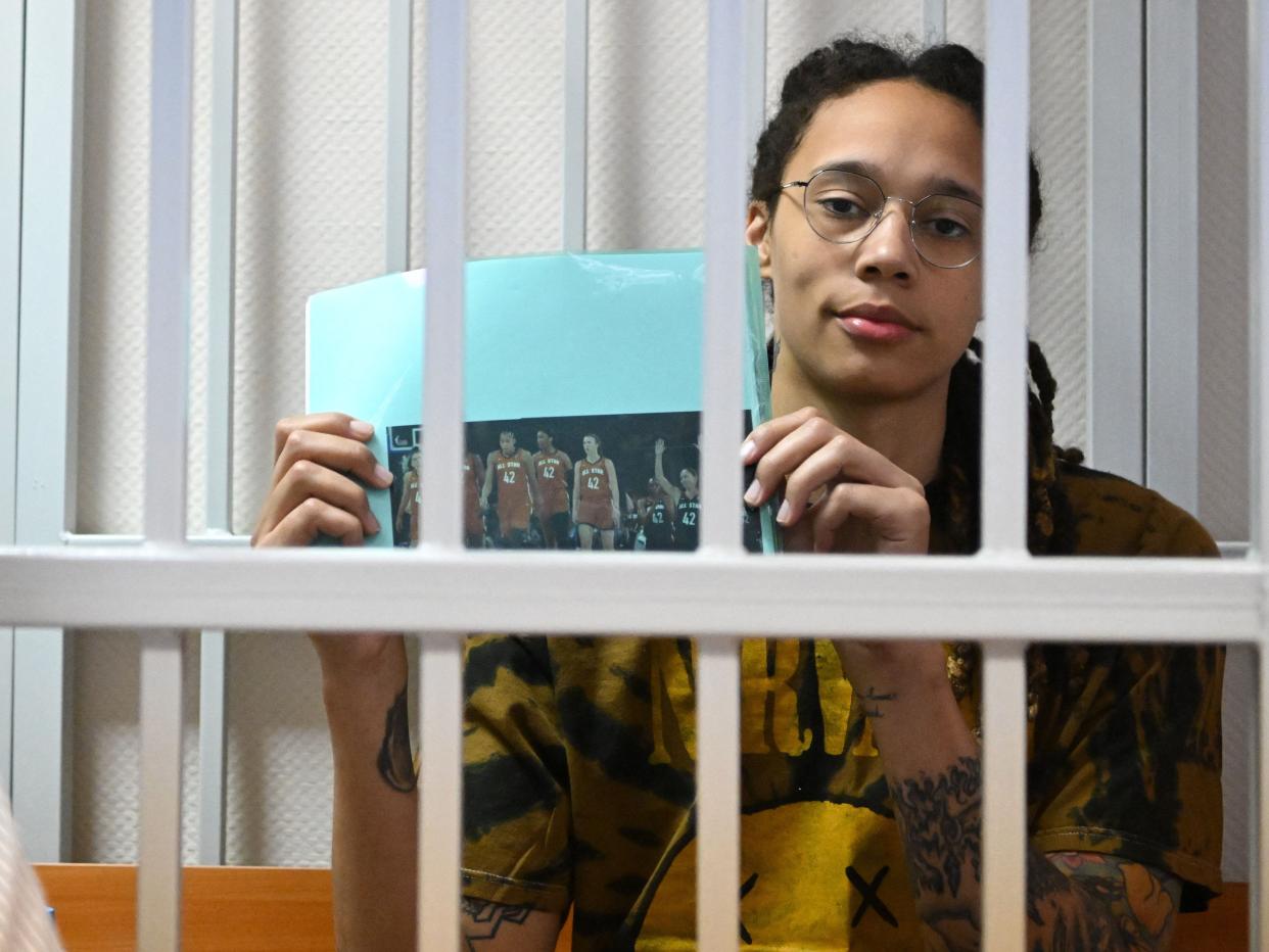 US WNBA basketball superstar Brittney Griner sits inside a defendants' cage during a hearing at the Khimki Court in the town of Khimki outside Moscow on July 15, 2022.