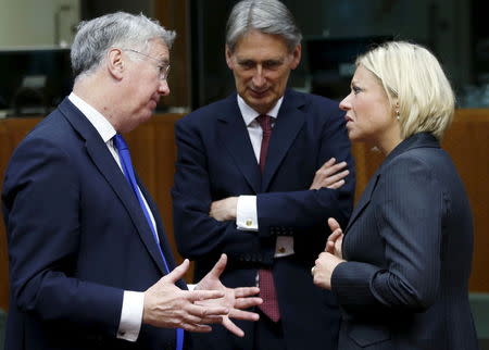 (L-R) British Defense Secretary Michael Fallon, Foreign Secretary Philip Hammond and Dutch Defence Minister Jeanine Hennis-Plasschaert attend a joint meeting of European Union foreign and defence ministers at the EU Council in Brussels, Belgium, May 18, 2015. REUTERS/Francois Lenoir