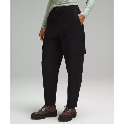 model wearing black cargo pants with green long sleeve