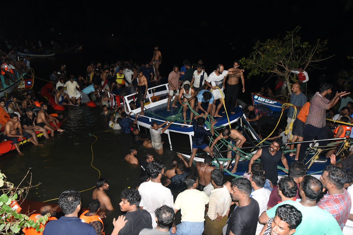 People carry out rescue operation at the site of a boat accident in Tanur in Kerala (AFP via Getty Images)