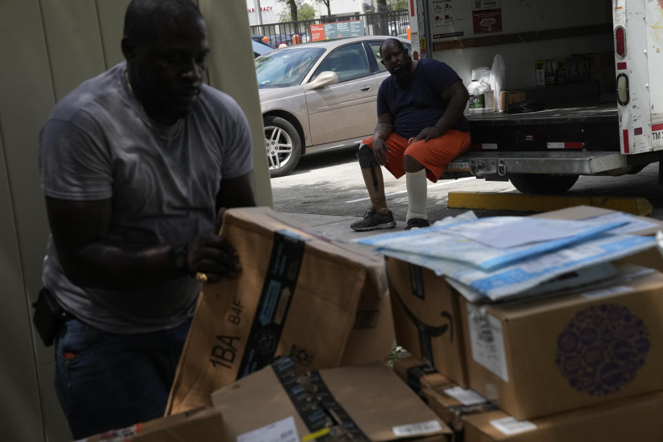 FILE - Freddie Davis, whose landlord raised his rent by 60 percent in the same month he lost his job as a truck driver, watches as his cousin Johnny McGriff moves boxes of his belongings into a storage unit, in preparation for an eviction that he knows could come at any time, on Sept. 6, 2021, in Miami. For your average Floridian, cost of living concerns have become an issue and really are not being addressed as vocally as most folks would have hoped. (AP Photo/Rebecca Blackwell, File)