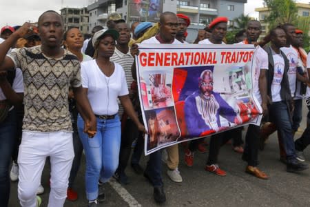 People march during a protest against corruption and economic failure in Monrovia