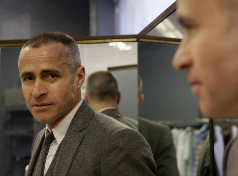 Fashion designer Thom Browne poses for a photograph in New York, Wednesday, Feb. 20, 2013. Browne is building a business _ and what he hopes is a smart, long-lasting business at that. He's just not the overzealous, mercurial artiste. (AP Photo/Kathy Willens)