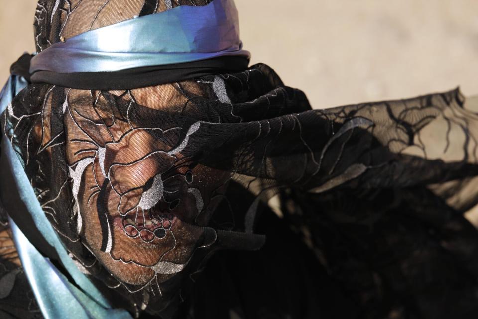 A man with a fabric shawl on his face