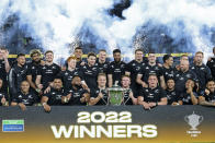 Members of the New Zealand All Blacks pose with the trophy after their win over Australia in their Bledisloe Cup rugby test match in Melbourne, Australia, Thursday, Sept 15, 2022. (AP Photo/Asanka Brendon Ratnayake)