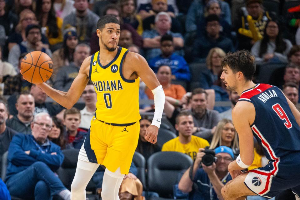 Dec 9, 2022; Indianapolis, Indiana, USA; Indiana Pacers guard Tyrese Haliburton (0) passes the ball while Washington Wizards forward Deni Avdija (9) defends in the second half at Gainbridge Fieldhouse. Mandatory Credit: Trevor Ruszkowski-USA TODAY Sports