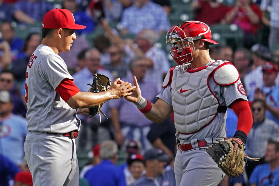 St. Louis Cardinals relief pitcher Giovanny Gallegos, left, celebrates with catcher Andrew Knizner after they defeated the Chicago Cubs in the first baseball game of a doubleheader in Chicago, Friday, Sept. 24, 2021. (AP Photo/Nam Y. Huh)