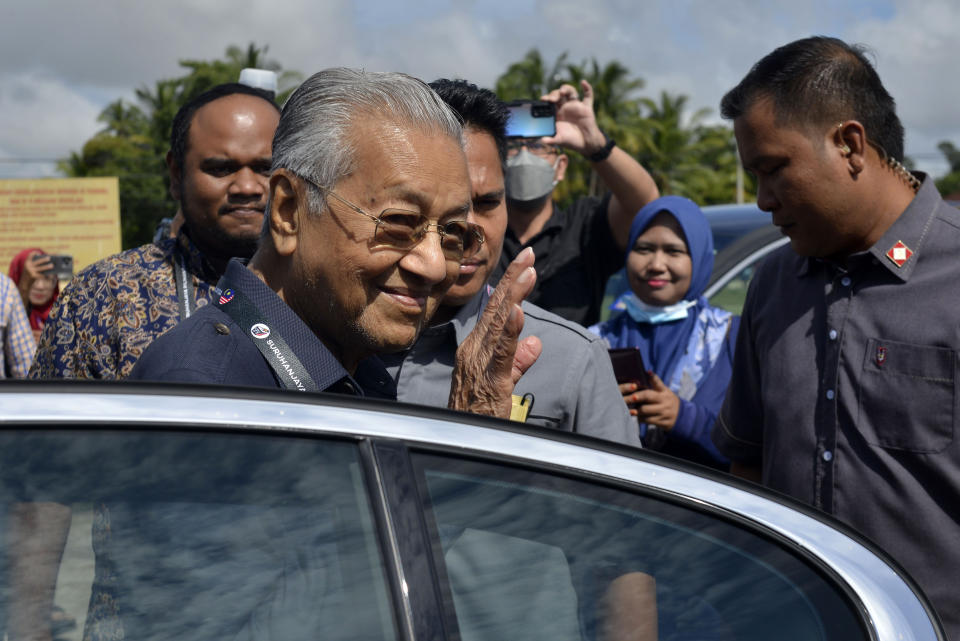 Former Malaysia Prime Minister and Gerakan Tanah Air (Homeland Party) chairman Mahathir Mohamad waves on his arrival at a voting center to cast his ballot for the general election in Alor Setar, Kedah, Malaysia, Saturday, Nov. 19, 2022. Malaysians have begun casting ballots in a tightly contested national election that will determine whether the country’s longest-ruling coalition can make a comeback after its electoral defeat four years ago. (AP Photo/JohnShen Lee)