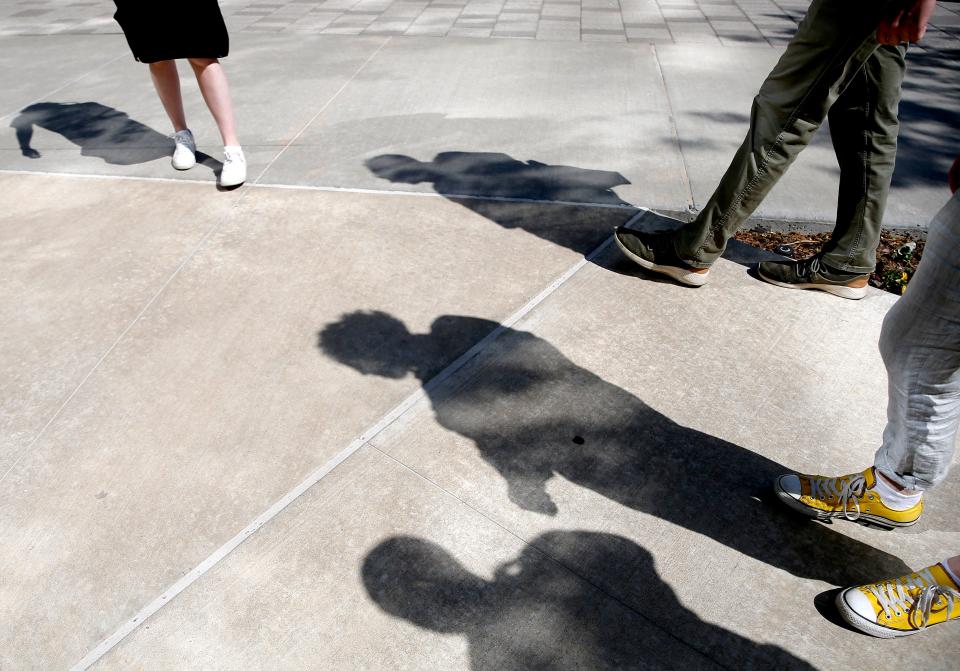 Members of the creative team walk the path of the guided audio tour for Oklahoma City Repertory Theater's "Of a Mind: Oklahoma City" in Oklahoma City, Friday, April, 15, 2022.