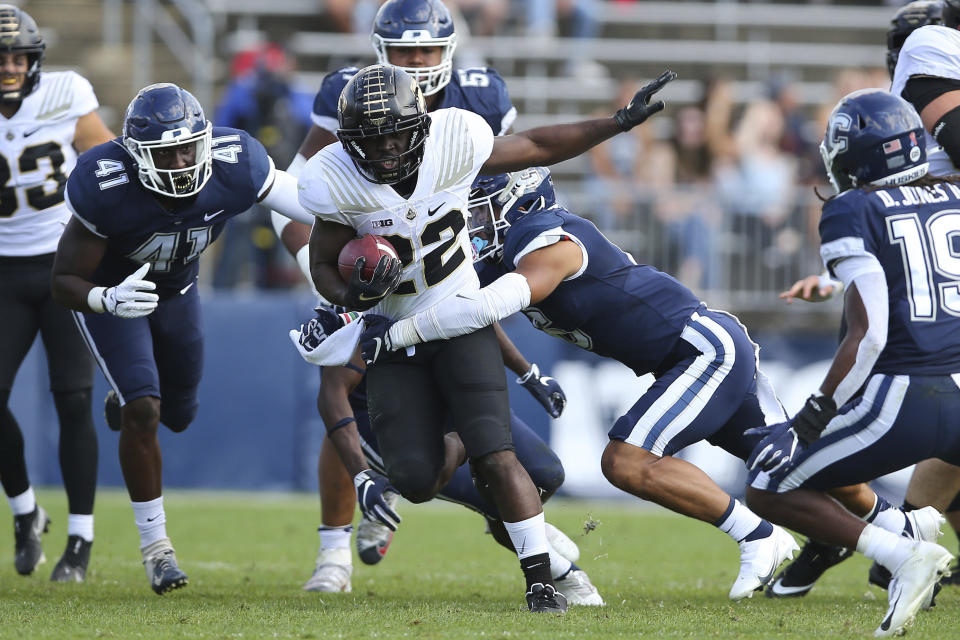 Connecticut defensive back Alfred Chea (22) is tackled by Purdue linebacker Jalen Graham (6) during the first half of an NCAA football game on Saturday, Sept. 11, 2021, in East Hartford, Conn. (AP Photo/Stew Milne)