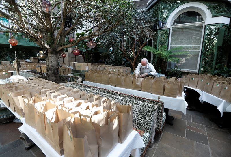 A worker from Annabel's private members club prepares meal packs for NHS staff at their premises in London