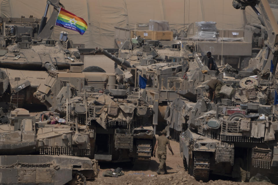 Israeli soldiers stand on top of armoured vehicles in a staging area near the Israeli-Gaza border in southern Israel, Monday, June 3, 2024. (AP Photo/Leo Correa)