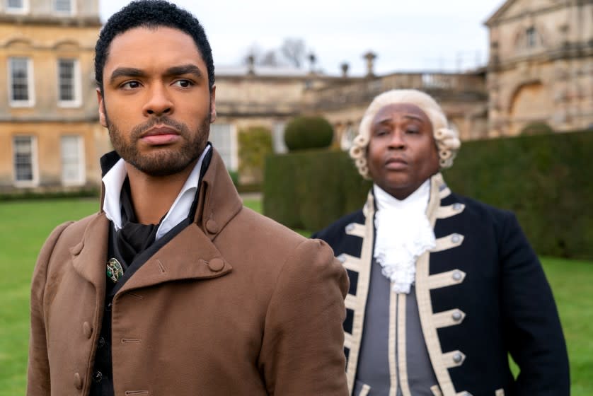 Regé-Jean Page as Simon Basset (left) wears his mother's brooch near his collar.