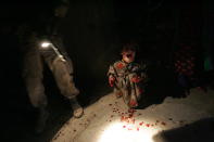 <p>Samar Hassan, 5, screams after her parents were killed by U.S. Soldiers with the 25th Infantry Division in a shooting January 18, 2005 in Tal Afar, Iraq. The troops fired on the Hassan family car when it unwittingly approached them during a dusk patrol in the tense northern Iraqi town. Parents Hussein and Camila Hassan were killed instantly, and son Racan, 11, was seriously wounded in the abdomen. Racan, paralyzed from the waist down, was treated later in the U.S. (Photo by Chris Hondros/Getty Images) </p>