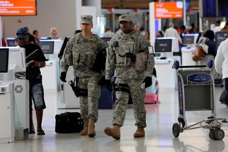 Members of the U.S. Army monitor the departures area at John F. Kennedy international Airport in the Queens borough of New York, U.S., June 29, 2016. REUTERS/Andrew Kelly
