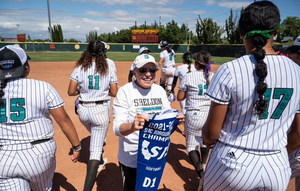 Sheldon High School softball coach Mary Jo Truesdale holds the team’s pennant after defeating Lincoln of Stockton for the CIF Sac-Joaquin Section Division I title in 2022. The Huskies are seed No. 9 in this year’s bracket.