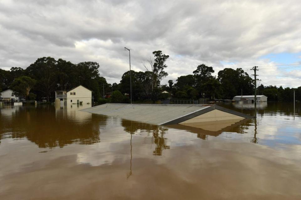 Houses inundated with floodwaters from an overflowing Hawkesbury River are pictured in the Windsor suburb of Sydney (AFP via Getty Images)