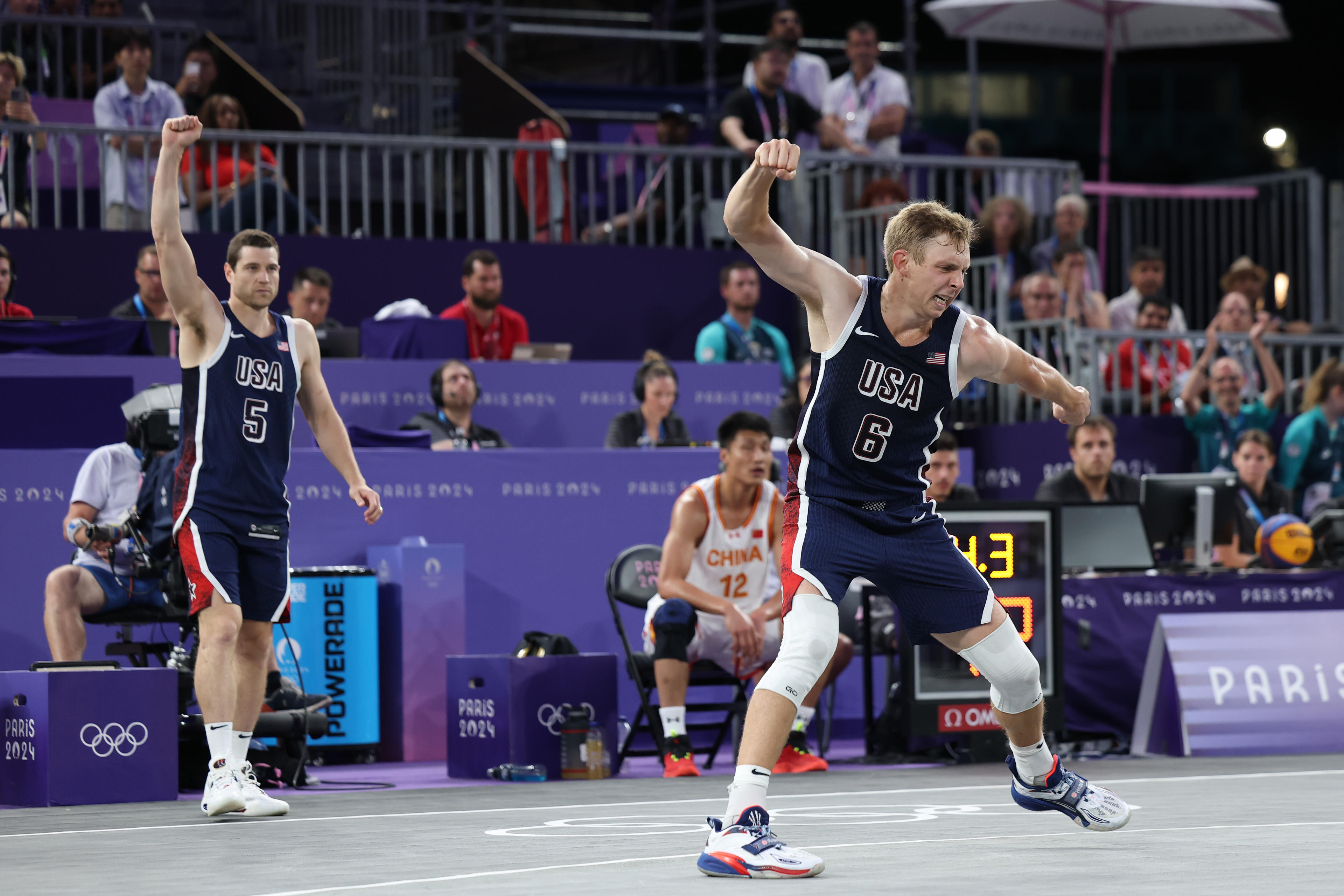 Jimmer Fredette and Canyon Barry of Team United States celebrate after their team's victory against China during a Men's 3x3 Basketball Pool Round at the Olympics at Esplanade Des Invalides on August 02, 2024 in Paris, France. (Lintao Zhang/Getty Images)