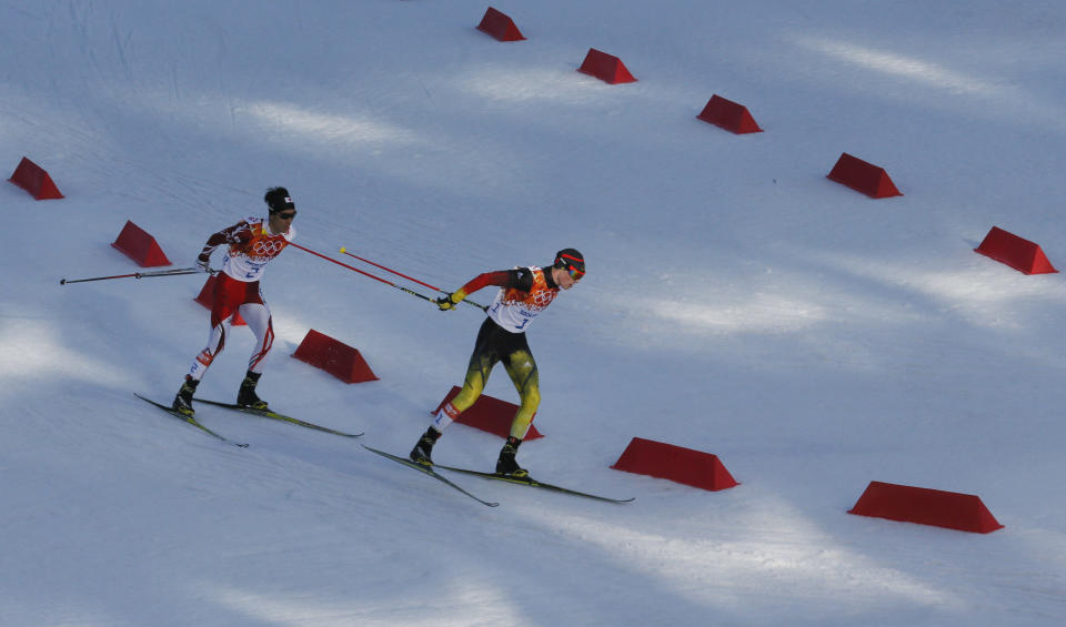 Germany's gold medal winner Eric Frenzel, right, and Japan's silver medal winner Akito Watabe ski during the cross-country portion of the Nordic combined at the 2014 Winter Olympics, Wednesday, Feb. 12, 2014, in Krasnaya Polyana, Russia. (AP Photo/Dmitry Lovetsky)