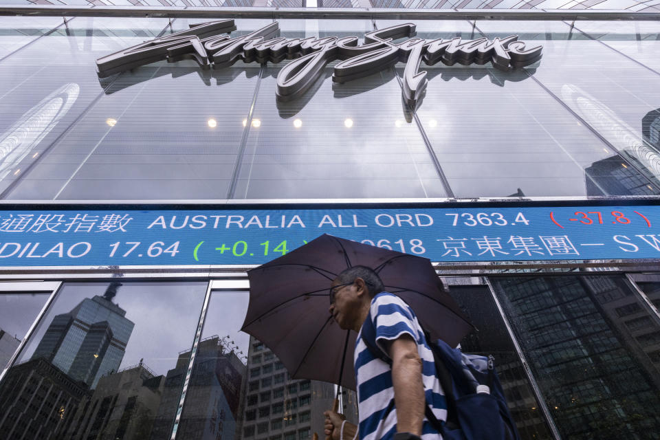 A pedestrian passes by the electronic screen of the Hong Kong Stock Exchange in Hong Kong, Tuesday, June 6, 2023. Asian stock markets rose Tuesday after Wall Street fell on concern the U.S. economy may be weakening following a report that showed growth in service industries slowing.(AP Photo/Louise Delmotte)