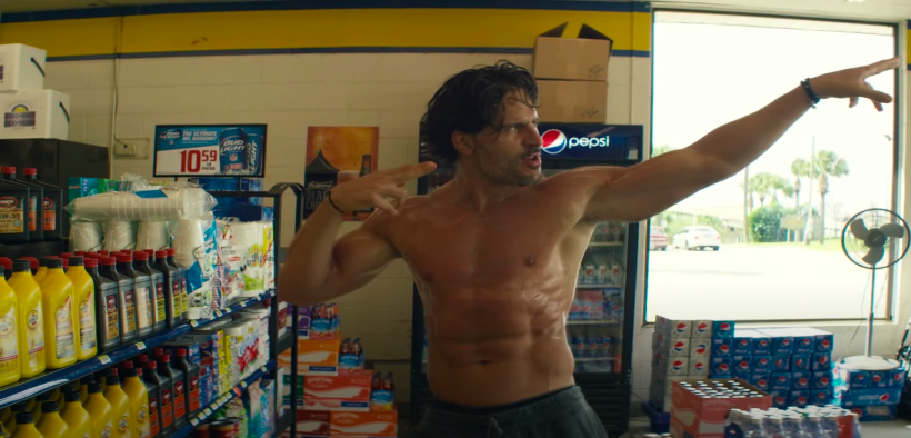 A man dances shirtless in a gas station