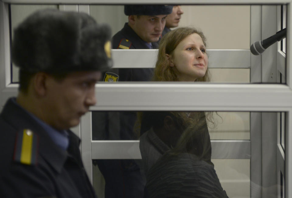 Jailed feminist punk band Pussy Riot member Maria Alekhina is seen in a cell at a court room in the town of Berezniki, some 1500 km (940 miles) north-east of Moscow, Russia, on Wednesday, Jan. 16, 2013. (AP Photo/Alexander Agafonov)
