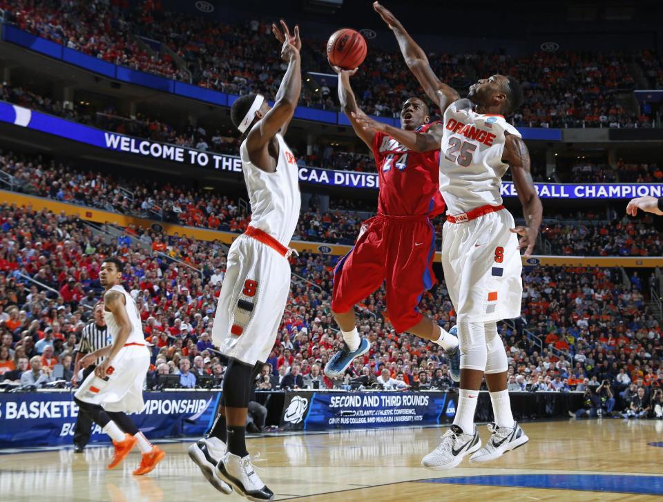 Dayton's Jordan Sibert (24) drives past Syracuse's Rakeem Christmas (25) during the first half of a third-round game in the NCAA men's college basketball tournament in Buffalo, N.Y., Saturday, March 22, 2014. (AP Photo/Bill Wippert)