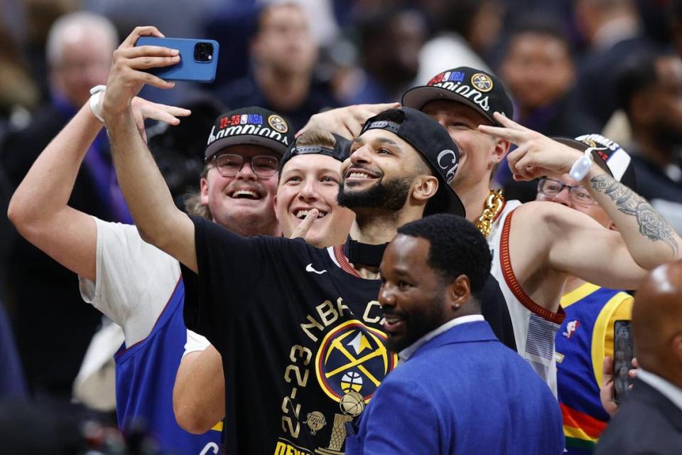 Former Kentucky guard Jamal Murray of the Denver Nuggets celebrates with fans after winning the 2023 NBA championship against the Miami Heat.