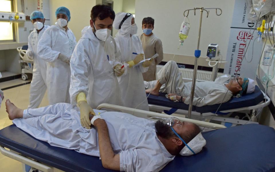 In Afghanistan, the two main hospitals treating people with Covid-19 have had to close their doors to new patients because of a lack of beds - WAKIL KOHSAR / AFP